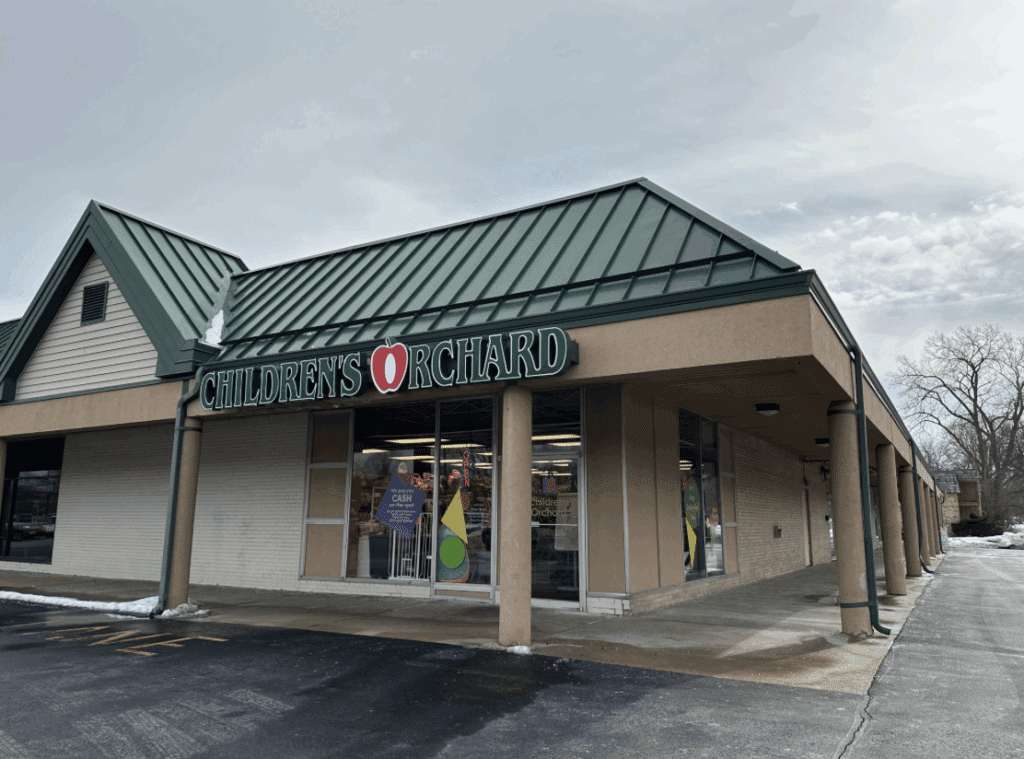 Exterior of Children's Orchard in New Berlin with green lettering on a cloudy day.